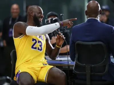El Segunda, CA, Monday, September 29, 2025 - LeBron James shares a laugh with James Worthy and others during a television interview at media day at UCLA Health Training Center. (Robert Gauthier/Los Angeles Times)