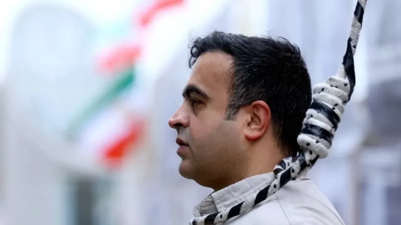 A man wears a noose around his neck as supporters of the National Council of Resistance of Iran gather to protest against the death penalty in their home country and for the Islamic Revolutionary Guard Corps to be declared a "terrorist organization," in Berlin, Germany, November 14, 2024. (photo credit: Lisi Niesner/Reuters)