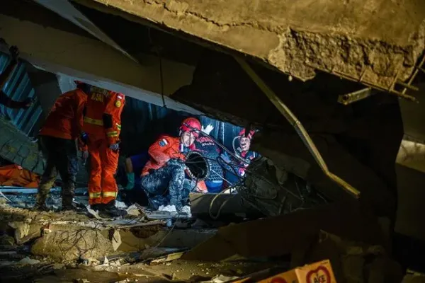 JUNI KRISWANTO/AFP via Getty Rescue personnel searching for survivors at the Al Khoziny boarding school in Sidoarjo, East Java province on September 29, 2025