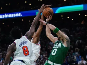 May 7, 2025; Boston, Massachusetts, USA; New York Knicks forward Mikal Bridges (25) defends against Boston Celtics forward Jayson Tatum (0) in the last seconds of the fourth quarter during game two of the second round for the 2025 NBA Playoffs at TD Garden. 