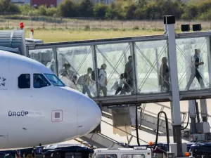 People from Afghanistan leave a plane after landing at Hanover-Langenhagen Airport. After months of waiting, several families have arrived in Germany with the promise of admission. Michael Matthey/dpa
