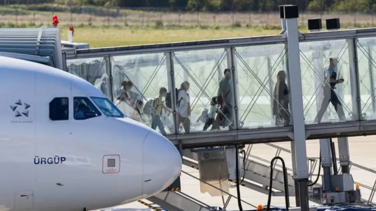 People from Afghanistan leave a plane after landing at Hanover-Langenhagen Airport. After months of waiting, several families have arrived in Germany with the promise of admission. Michael Matthey/dpa