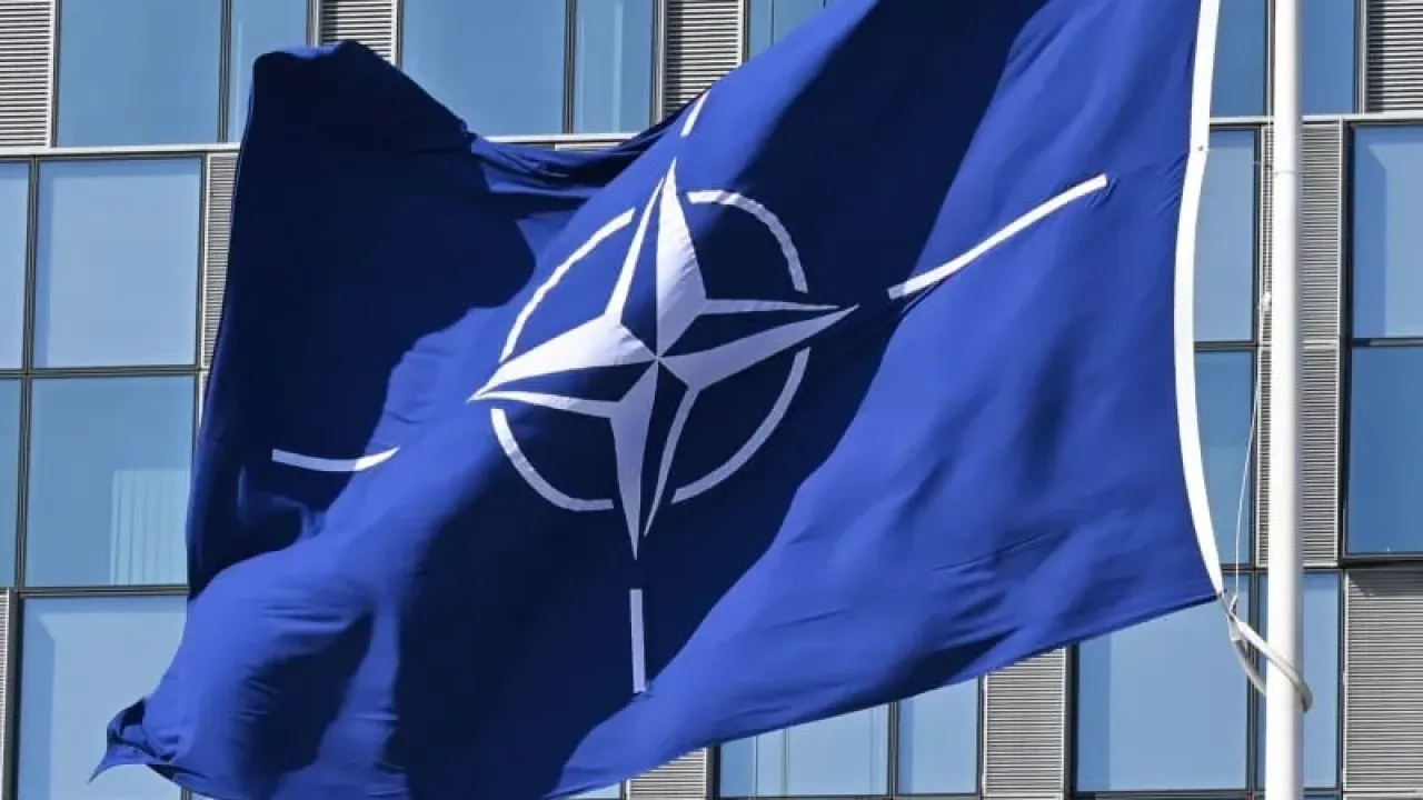 A NATO flag flies in the wind in front of the NATO headquarters in Brussels. Anna Ross/dpa