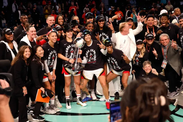 NEW YORK, NEW YORK - OCTOBER 18: Kelsey Plum #10 of the Las Vegas Aces holds the trophy while celebrating with her team after defeating the New York Liberty during Game Four of the 2023 WNBA Finals at Barclays Center on October 18, 2023 in New York City. The Aces defeated the Liberty 70-69. (Photo by Sarah Stier/Getty Images)