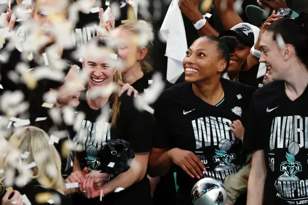 NEW YORK, NEW YORK - OCTOBER 20: Sabrina Ionescu #20 of the New York Liberty and Head coach Sandy Brondello celebrate after winning Game Five of the WNBA Finals at Barclays Center on October 20, 2024 in New York City. (Photo by Sarah Stier/Getty Images)