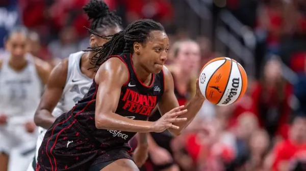 Indiana Fever guard Kelsey Mitchell heads upcourt with the ball in the second half of Game 4 against the Las Vegas Aces in Indianapolis on Sunday. - Doug McSchooler/AP