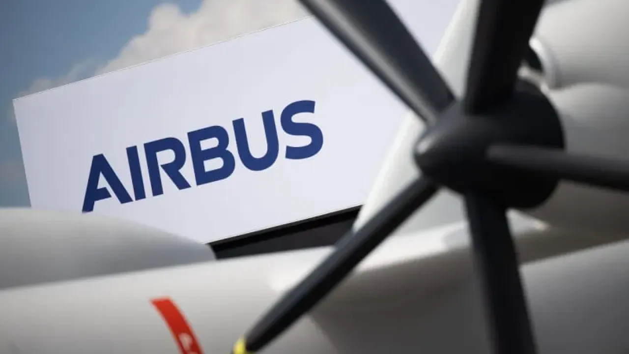 The Airbus logo can be seen behind a model of the Eurodrone during the International Aerospace Exhibition (ILA) at Berlin Brandenburg Airport (BER). Sebastian Gollnow/dpa