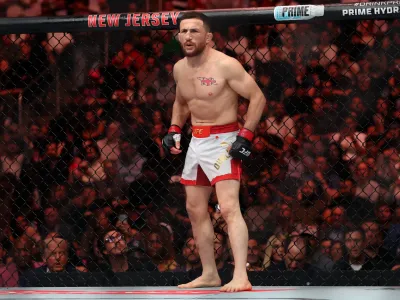 Jun 7, 2025; Newark, New Jersey, UNITED STATES; Merab Dvalishvili (red gloves) prepares to fight Sean O’Malley (not pictured) in a bantamweight title fight during UFC 316 at Prudential Center. Mandatory Credit: Vincent Carchietta-Imagn Images