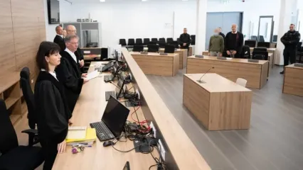 Hans Schlueter-Staats (2nd L), presiding judge at the Dresden Higher Regional Court (OLG), stands next to the main defendant Jian G. (C) in the courtroom during the espionage trial of a former employee of Alternative for Germany (AfD) member of parliament Maximilian Krah and his alleged accomplice, as the court delivers its verdict. Sebastian Kahnert/dpa-pool/dpa