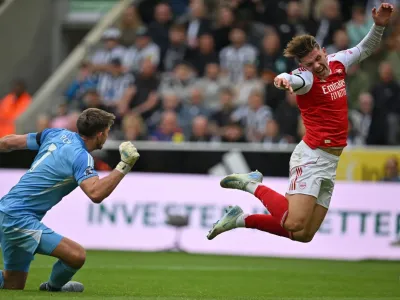 Arsenal&#39;s Viktor Gyokeres goes down after a challenge by Newcastle goalkeeper Nick Pope