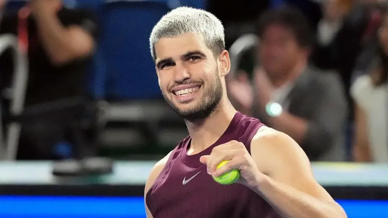 Carlos Alcaraz has a tennis ball in his hand