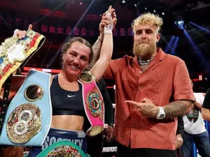 Ellie Scotney's hand is held up by Jake Paul 