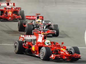 Felipe Massa of Ferrari leads from Lewis Hamilton of McLaren Mercedes and Kimi Raikkonen Ferrari at the start of the Singapore Grand Prix