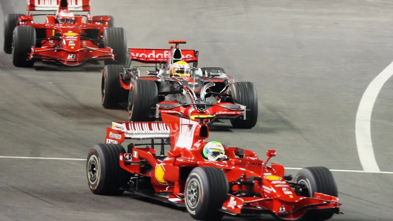 Felipe Massa of Ferrari leads from Lewis Hamilton of McLaren Mercedes and Kimi Raikkonen Ferrari at the start of the Singapore Grand Prix
