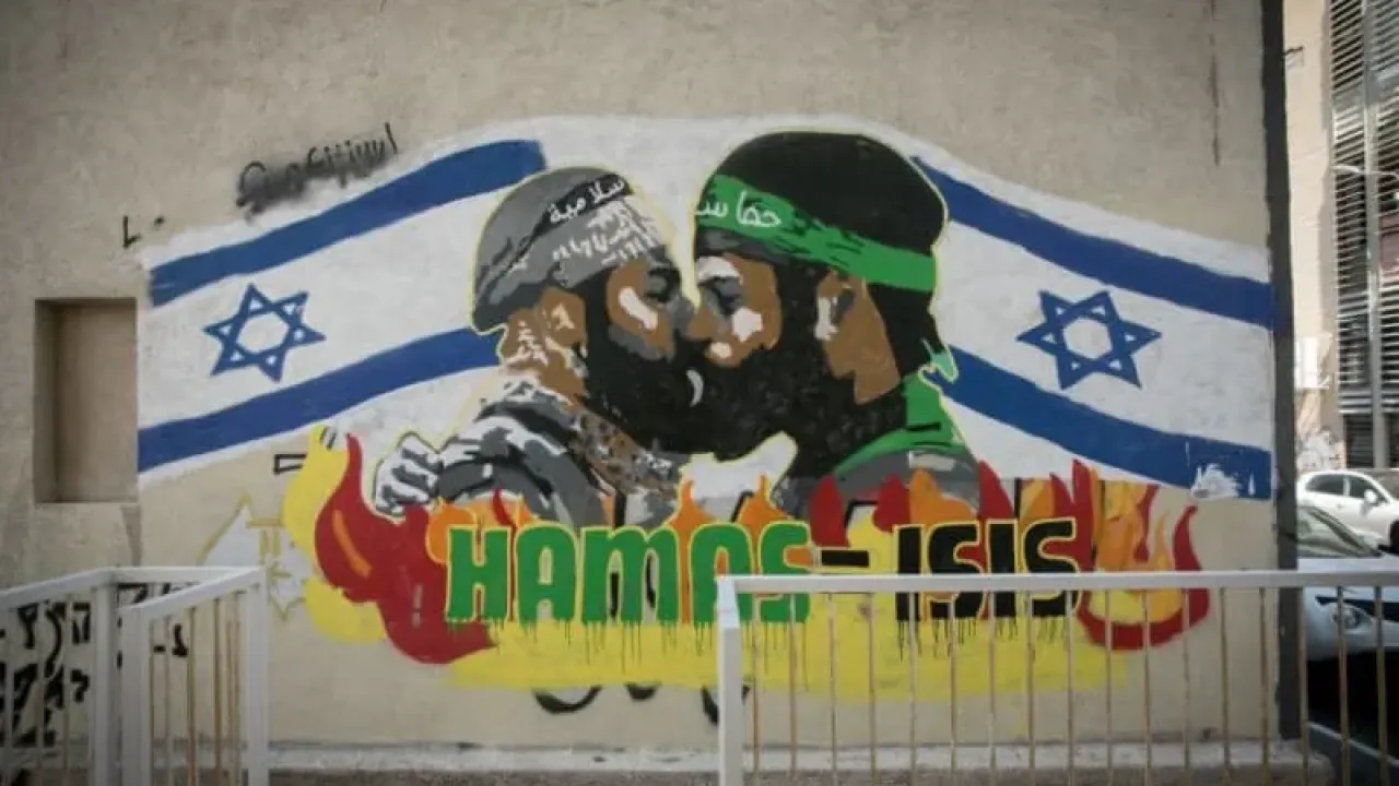 Grafitti shows terrorists from Hamas and ISIS kissing, in south Tel Aviv, September 29, 2024 (credit: MIRIAM ALSTER/FLASH90)
