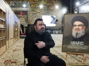 Jawad Nasrallah, son of late Hezbollah leader Hassan Nasrallah, reacts at the burial site ahead of the first anniversary of his father