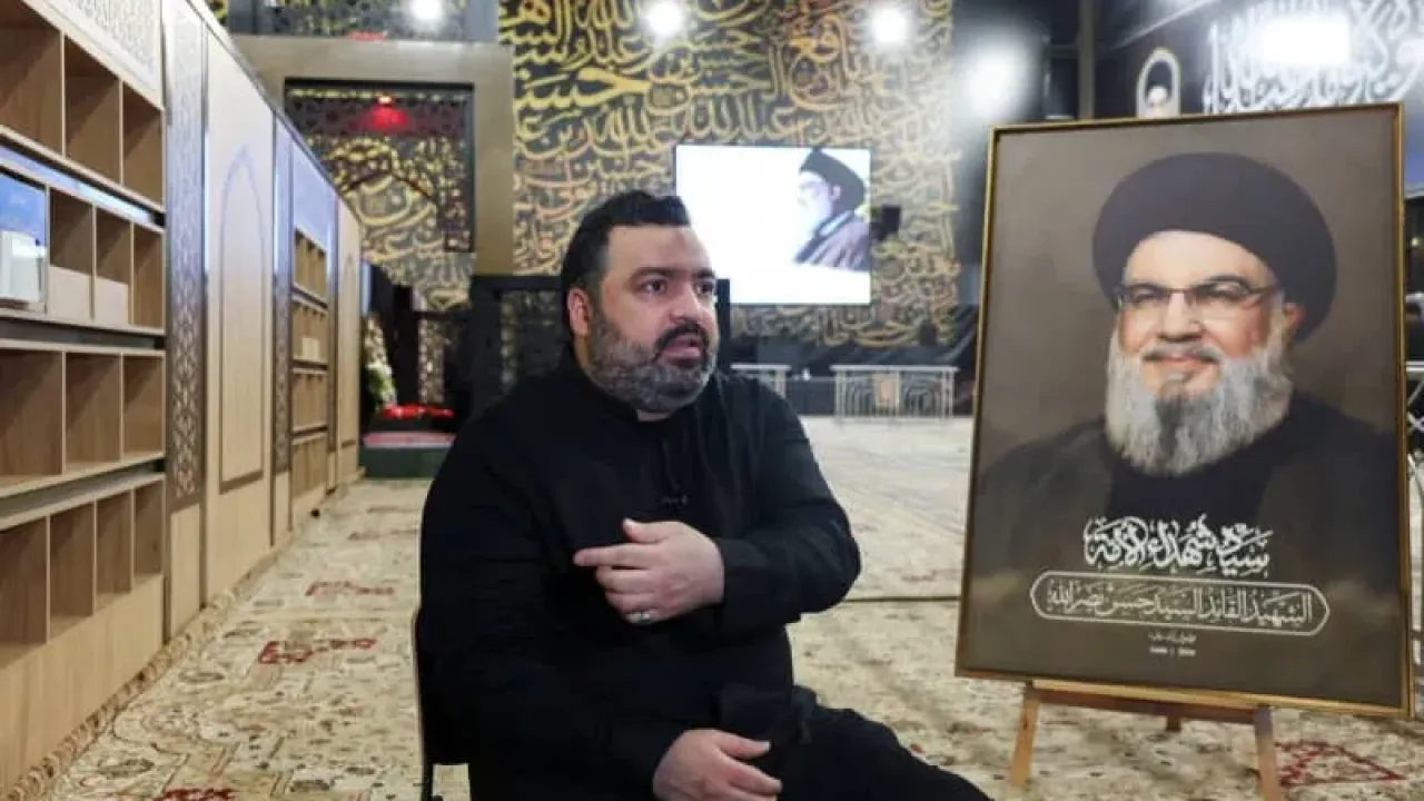Jawad Nasrallah, son of late Hezbollah leader Hassan Nasrallah, reacts at the burial site ahead of the first anniversary of his father