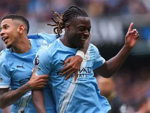 Jeremy Doku of Manchester City celebrates with teammate Savinho