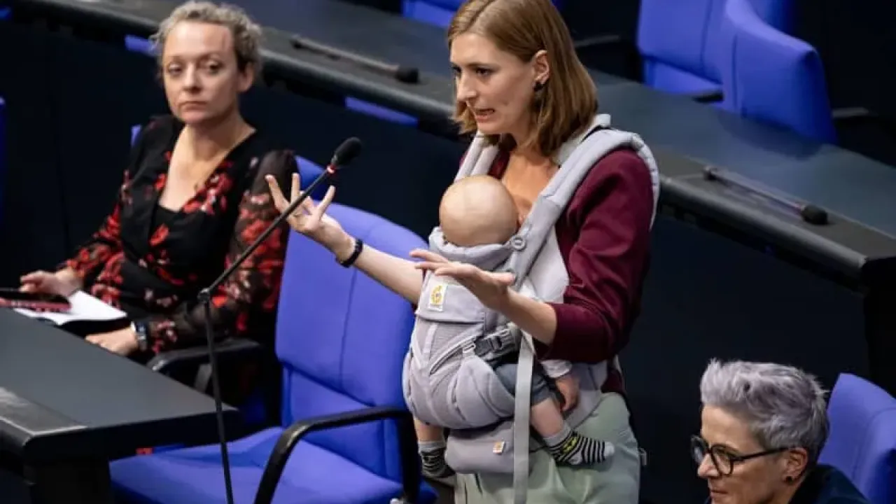 Member of the German Bundestag Hanna Steinmueller speaks at a session of the Bundestag with her child on her stomach. Fabian Sommer/dpa
