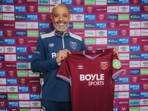 Nuno Espirito Santo holds up a West Ham shirt after being appointed as head coach