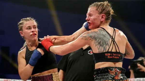 Paige VanZant punches Britain Hart on the chin in a bare-knuckle fight