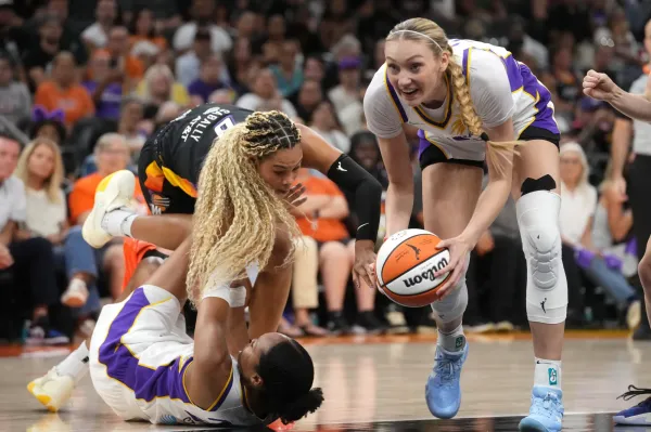 Phoenix Mercury forward Satou Sabally loses the ball to Los Angeles Sparks forward Cameron Brink.