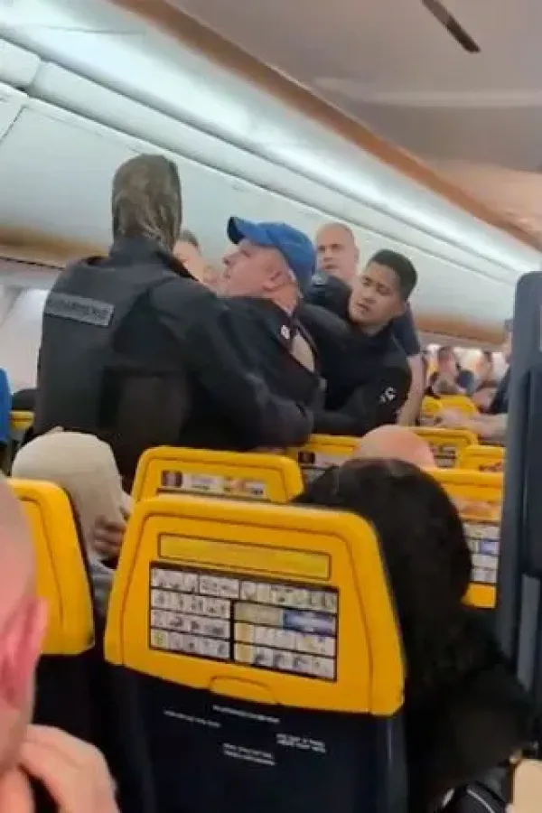 SWNS A Ryanair passenger is removed by French police.