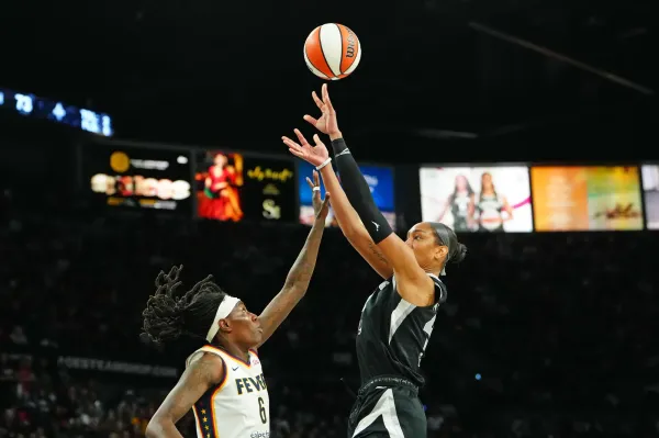 Sep 30, 2025; Las Vegas, Nevada, USA; Las Vegas Aces center A'ja Wilson (22) shoots against Indiana Fever forward Natasha Howard (6) during the fourth quarter of game five of the second round for the 2025 WNBA Playoffs at Michelob Ultra Arena. Mandatory Credit: Stephen R. Sylvanie-Imagn Images
