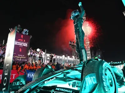 Race winner George Russell of Great Britain and Mercedes AMG Petronas F1 Team celebrates during the F1 Grand Prix of Singapore at Marina Bay Street Circuit today. - Mark Sutton/ Getty Images