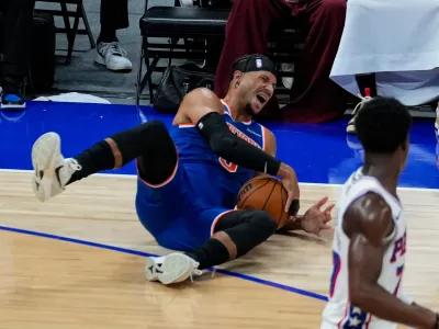 New York Knicks' Josh Hart reacts as he falls during the first half of an NBA preseason basketball game against the Philadelphia 76ers, Thursday, Oct. 2, 2025, in Abu Dhabi, United Arab Emirates. (AP Photo/Altaf Qadri)