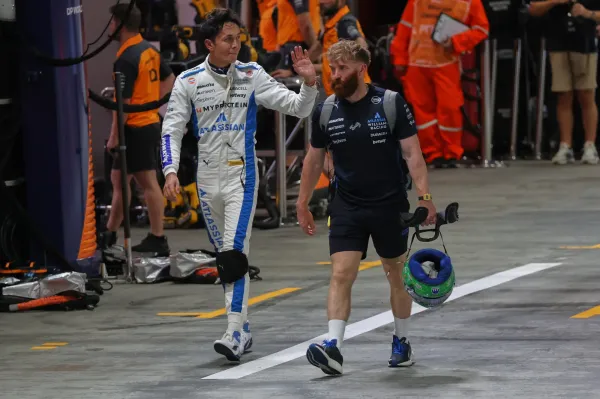Williams driver Alexander Albon of Thailand walks through the pit lane during the qualifying for the Singapore Formula One Grand Prix at the Marina Bay Street Circuit in Singapore, Saturday, Oct. 4, 2025. (AP Photo/Fazry Ismail, Pool) (ASSOCIATED PRESS)