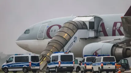 Police vehicles stand in front of a Qatar Airways plane at Leipzig/Halle Airport. Representatives from Germany&#39;s Interior Ministry have held discussions in Kabul on conducting regular deportation flights of Afghan criminal offenders, a ministry spokeswoman confirmed on Sunday. Jan Woitas/dpa