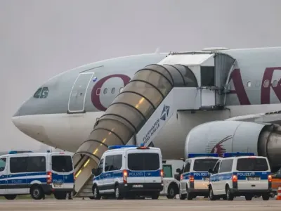Police vehicles stand in front of a Qatar Airways plane at Leipzig/Halle Airport. Representatives from Germany&#39;s Interior Ministry have held discussions in Kabul on conducting regular deportation flights of Afghan criminal offenders, a ministry spokeswoman confirmed on Sunday. Jan Woitas/dpa