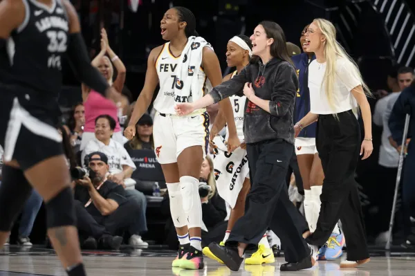 LAS VEGAS, NEVADA - SEPTEMBER 21: Aliyah Boston #7, Shey Peddy #5, Caitlin Clark #22, and Sophie Cunningham #8 of the Indiana Fever cheer for their team against the Las Vegas Aces at end of the third quarter of Game One of the 2025 WNBA Playoffs semifinals.