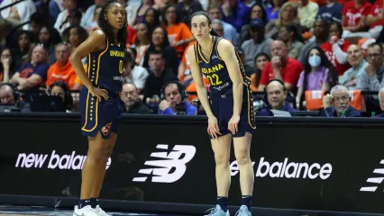 UNCASVILLE, CT - SEPTEMBER 22: Indiana Fever guard Kelsey Mitchell (0) speaks with Indiana Fever guard Caitlin Clark (22) as she waits to enter the game during the First Round and game 1 of the 2024 WNBA playoffs between Indiana Fever and Connecticut Sun on September 22, 2024, at Mohegan Sun Arena in Uncasville, CT. (Photo by M. Anthony Nesmith/Icon Sportswire via Getty Images)Icon Sportswire&sol;Getty Images