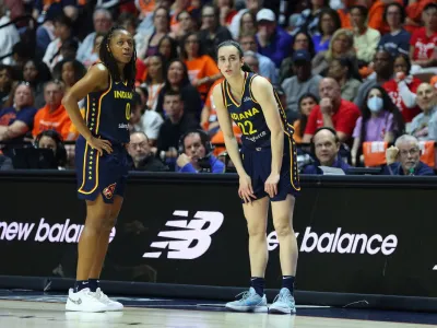 UNCASVILLE, CT - SEPTEMBER 22: Indiana Fever guard Kelsey Mitchell (0) speaks with Indiana Fever guard Caitlin Clark (22) as she waits to enter the game during the First Round and game 1 of the 2024 WNBA playoffs between Indiana Fever and Connecticut Sun on September 22, 2024, at Mohegan Sun Arena in Uncasville, CT. (Photo by M. Anthony Nesmith/Icon Sportswire via Getty Images)Icon Sportswire&sol;Getty Images