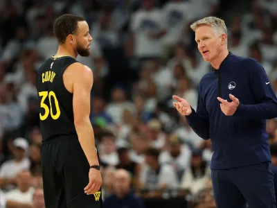 MINNEAPOLIS, MINNESOTA - MAY 06: Head coach Steve Kerr talks to Stephen Curry #30 of the Golden State Warriors in the second quarter of Game One against the Minnesota Timberwolves during the Second Round of the 2025 NBA Playoffs at Target Center on May 06, 2025 in Minneapolis, Minnesota. The Warriors defeated the Timberwolves 99-88 to take a 1-0 series lead. NOTE TO USER: User expressly acknowledges and agrees that, by downloading and or using this photograph, User is consenting to the terms and conditions of the Getty Images License Agreement. (Photo by David Berding/Getty Images)