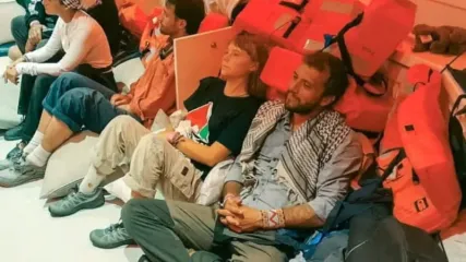 Swedish activist Greta Thunberg and Brazilian activist Thiago Avila sit in a vessel making their way to Israel, after Israel intercepted some of the vessels of the Global Sumud Flotilla, in this handout image released on October 2, 2025. (credit: ISRAEL FOREIGN MINSTRY/ Handout via REUTERS)