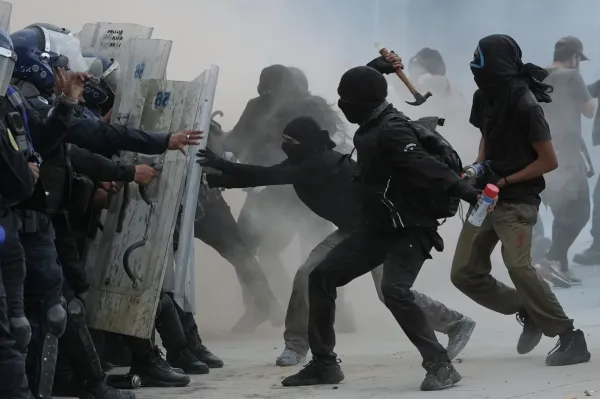 Demonstrators and riot police face off during a protest commemorating the anniversary of the 1968 Tlatelolco killings, when soldiers fired on student protesters, in Mexico City, Thursday, Oct. 2, 2025. (AP Photo/Claudia Rosel)(ASSOCIATED PRESS)
