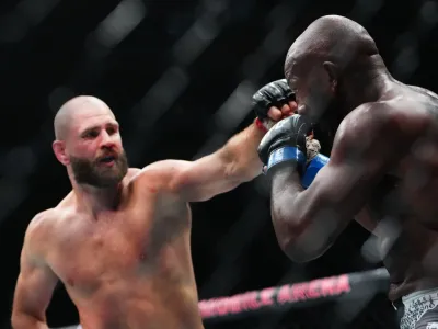 Oct 4, 2025; Las Vegas, Nevada, UNITED STATES; Jiri Prochazka (red gloves) fights Khalil Rountree Jr (blue gloves) during UFC 320 at T-Mobile Arena. Mandatory Credit: Stephen R. Sylvanie-Imagn Images