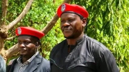 Bob Njagi and Nicholas Oyoo dressed in black clothing and wearing red berets associated with Uganda&#x002019;s opposition National Unity Platform (NUP), the party of Bobi Wine