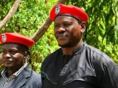 Bob Njagi and Nicholas Oyoo dressed in black clothing and wearing red berets associated with Uganda&#x002019;s opposition National Unity Platform (NUP), the party of Bobi Wine