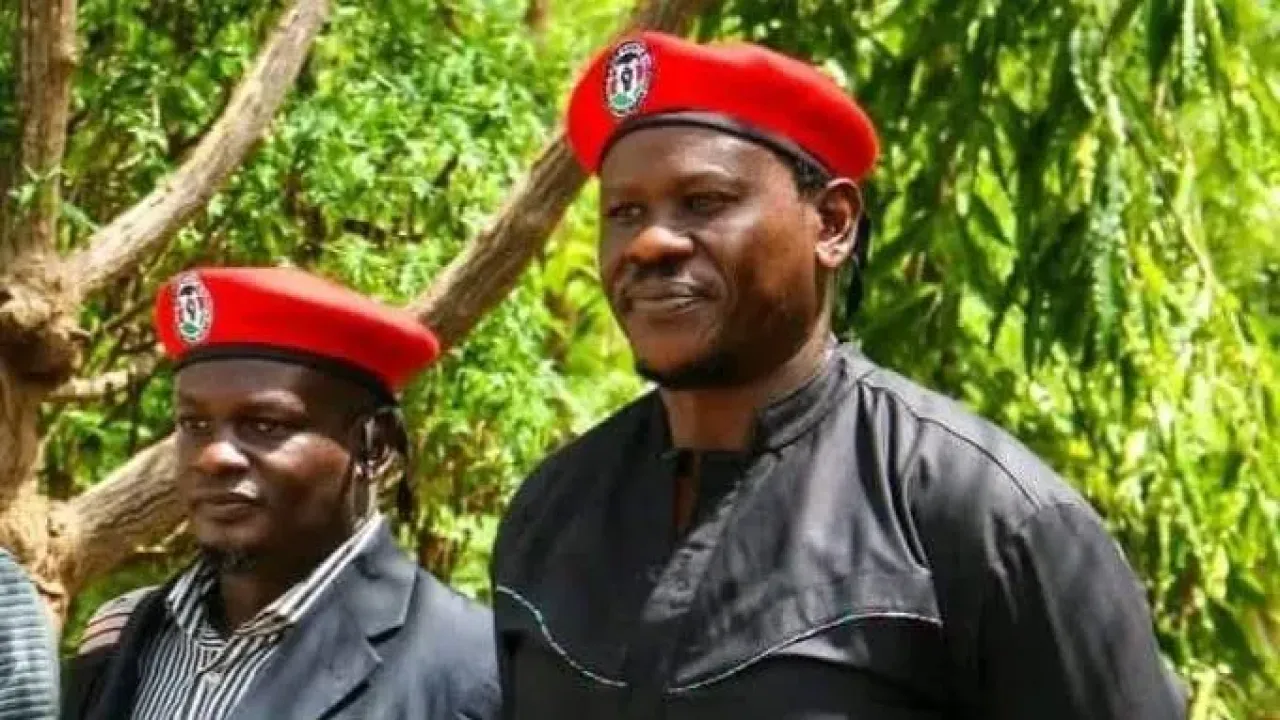 Bob Njagi and Nicholas Oyoo dressed in black clothing and wearing red berets associated with Uganda&#x002019;s opposition National Unity Platform (NUP), the party of Bobi Wine