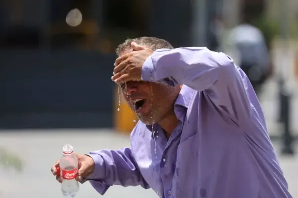 An Iranian taxi driver splashes water on himself to cool down during the heat surge in Tehran, Iran July 21, 2024. (photo credit: MAJID ASGARIPOUR/WANA (WEST ASIA NEWS AGENCY) VIA REUTERS)