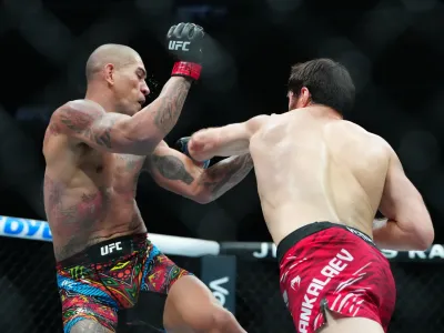 Mar 8, 2025; Las Vegas, Nevada, USA; Alex Pereira (red gloves) fights Magomed Ankalaev (blue gloves) during UFC 313 at T-Mobile Arena. Mandatory Credit: Stephen R. Sylvanie-Imagn Images