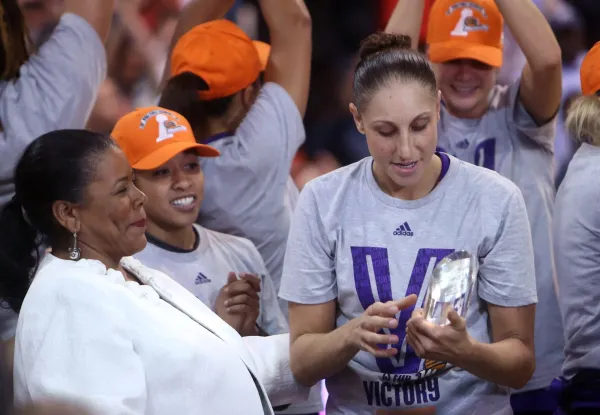 Sep 12, 2014; Chicago, IL, USA; Phoenix Mercury guard Diana Taurasi (right) is presented with the MVP trophy after game three of the 2014 WNBA Finals against the Chicago Sky at UIC Pavilion. Mandatory Credit: Jerry Lai-USA TODAY Sports