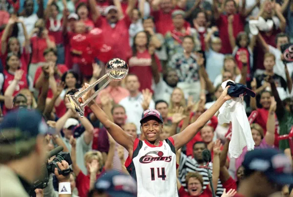 26 Aug 2000: Cynthia Cooper #14 of the Houston Comet celebrates by raising her trophy after winning the game against the New York Liberty in the WNBA Finals Game at the Compaq Center in Houston, Texas. The Comets defeated the Liberty 79-73 in overtime. Mandatory Credit: Ronald Martinez /Allsport