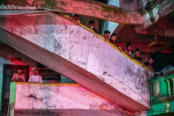 JUNI KRISWANTO/AFP via Getty Students watch as rescue personnel search for survivors after a building collapsed at an Islamic boarding school in Sidoarjo, East Java province on September 29, 2025