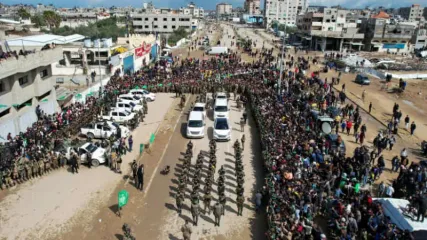A drone view shows Palestinians and Hamas militants gathering on the day of the release of Eliya Cohen, Omer Shem Tov, and Omer Wenkert, hostages held in Gaza since the deadly October 7, 2023 attack, as part of a ceasefire and a hostages-prisoners swap deal between Hamas and Israel, in Nuseirat, cen (credit: REUTERS/STRINGER)