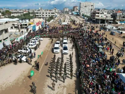 A drone view shows Palestinians and Hamas militants gathering on the day of the release of Eliya Cohen, Omer Shem Tov, and Omer Wenkert, hostages held in Gaza since the deadly October 7, 2023 attack, as part of a ceasefire and a hostages-prisoners swap deal between Hamas and Israel, in Nuseirat, cen (credit: REUTERS/STRINGER)